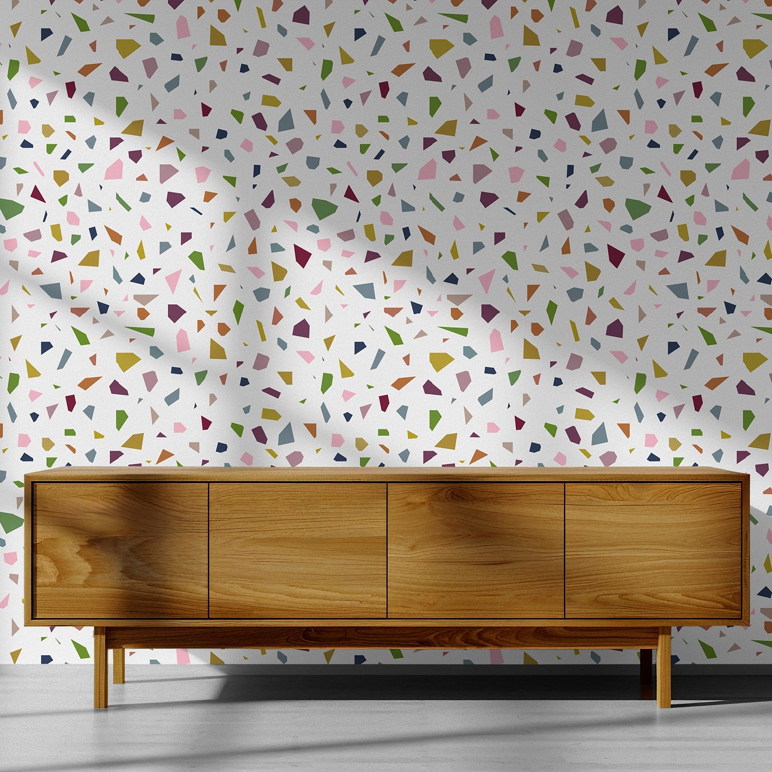 terrazzo mid century modern wallpaper on a wall behind a wood credenza