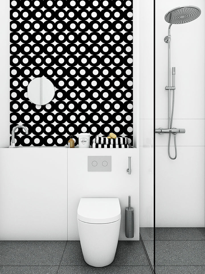 graphic black and white wallpaper in a very clean and modern bathroom