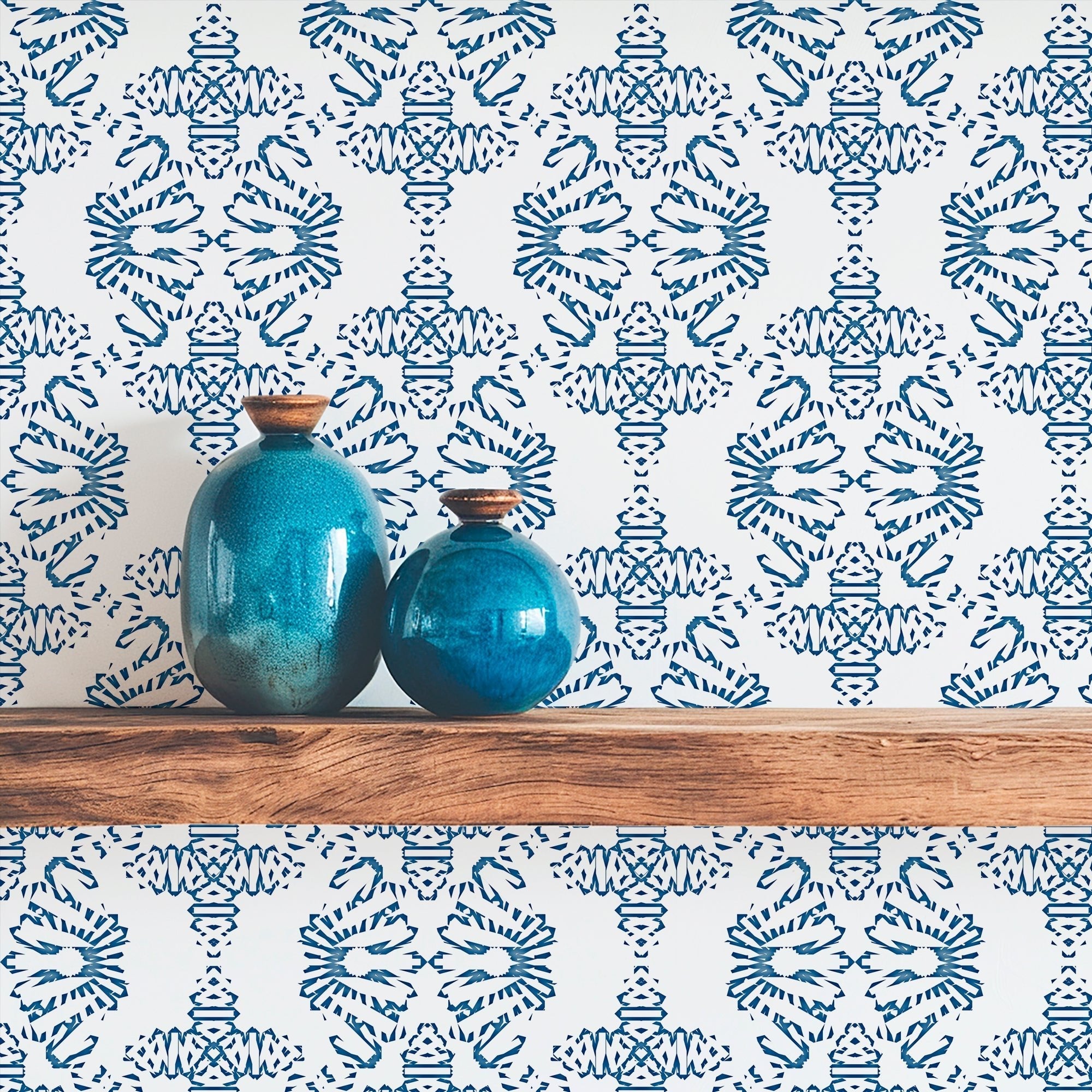 blue damask home office wallpaper on a wall behind a wood shelf