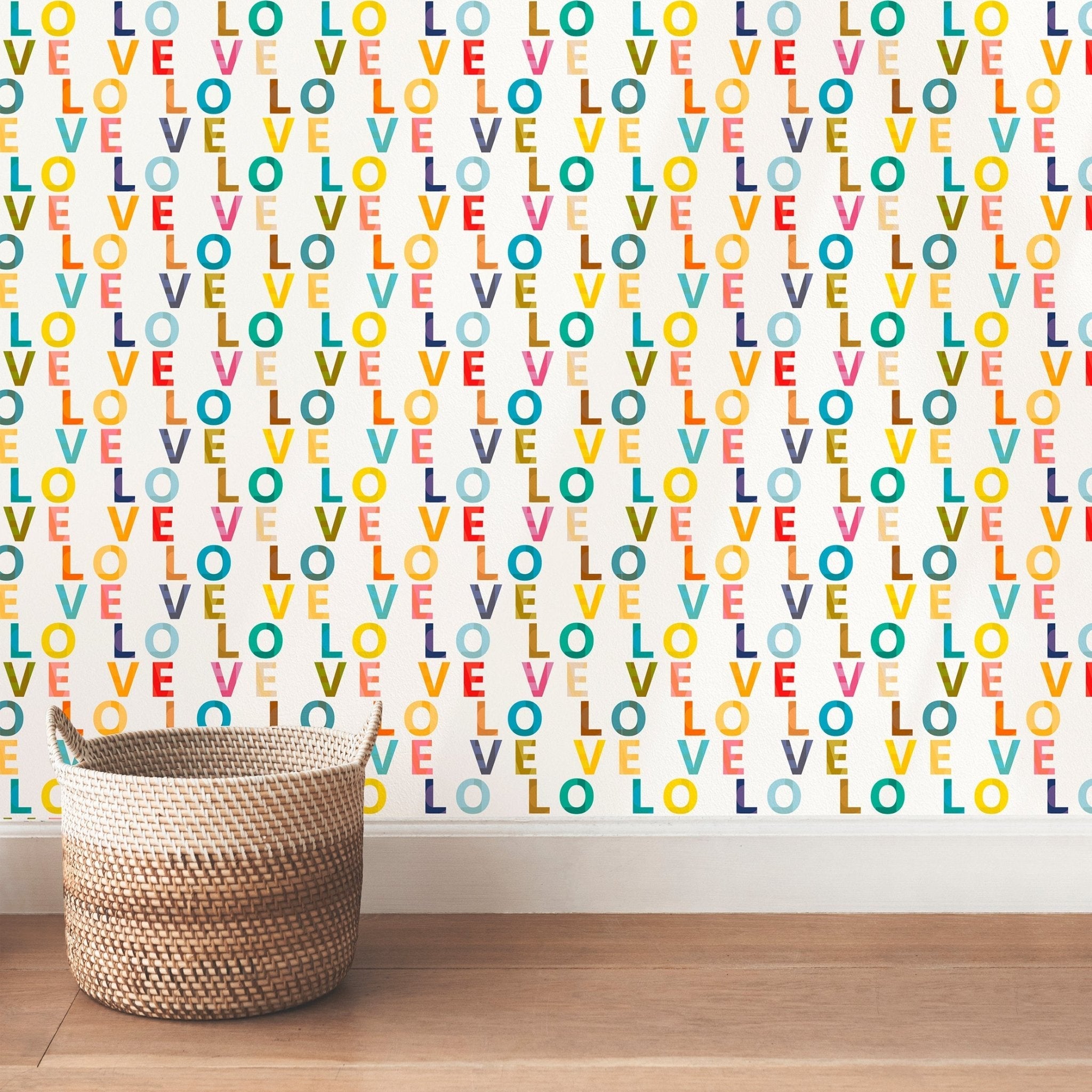 Love Love typography wallpaper shown on a wall behind a wicker basket