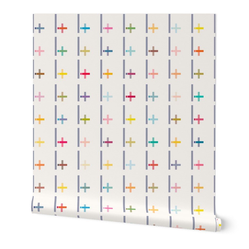 Roll of wallpaper with colorful cross pattern on a white background