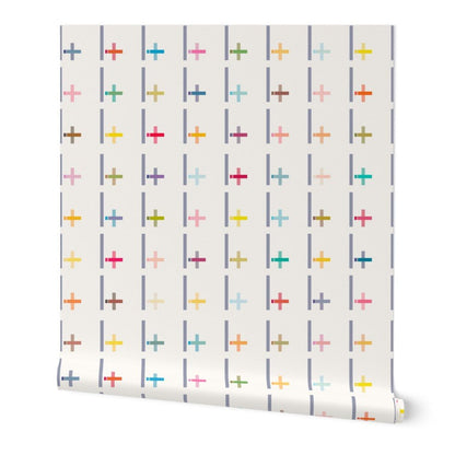 Roll of wallpaper with colorful cross pattern on a white background