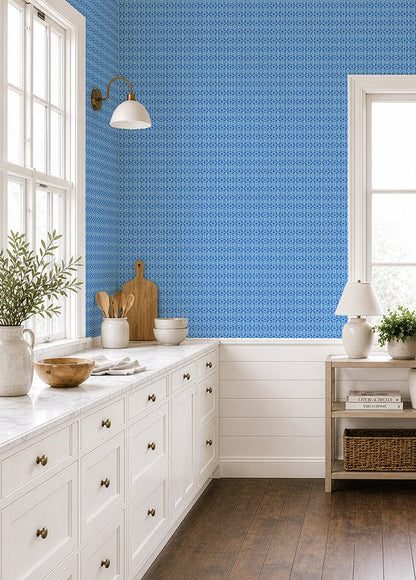 Calypso Blue wallpaper shown in a white beachy kitchen with wood floors